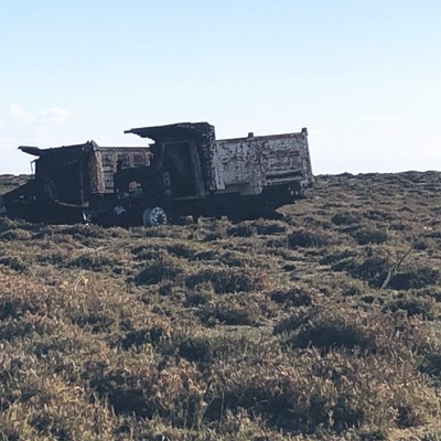 these burnt trucks on the side of san mateo del mar’s entrance road are a sign of the Ikoot community’s protest against proposed wind farm projects on their sacred land