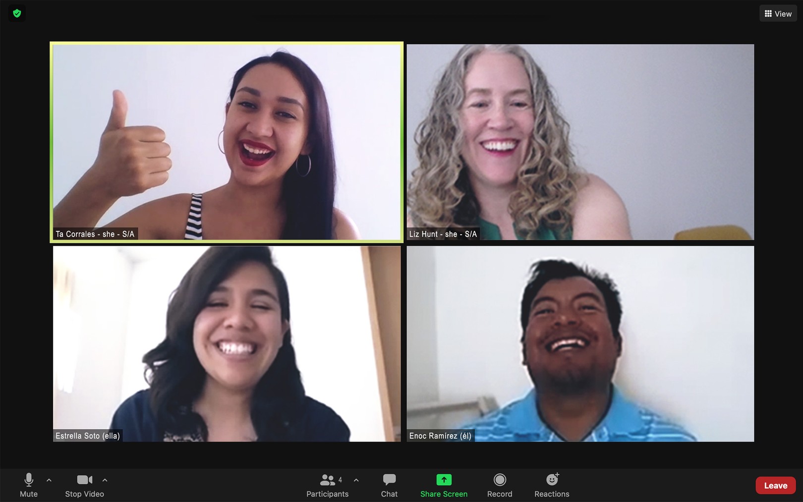 a screenshot of a zoom call in which the four participants are laughing
